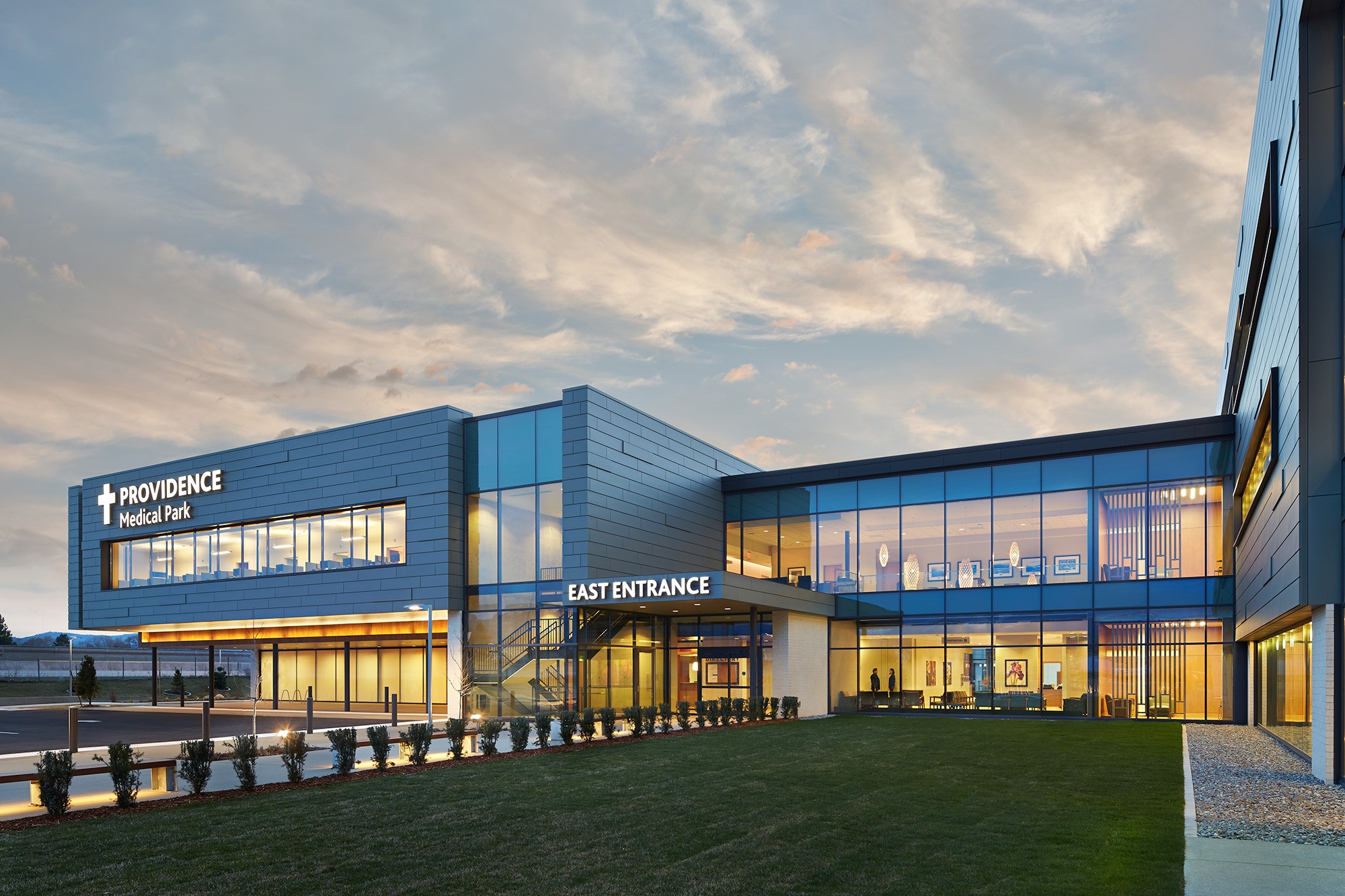 Providence Medical Park building featuring bright signage and warmly lit windows.